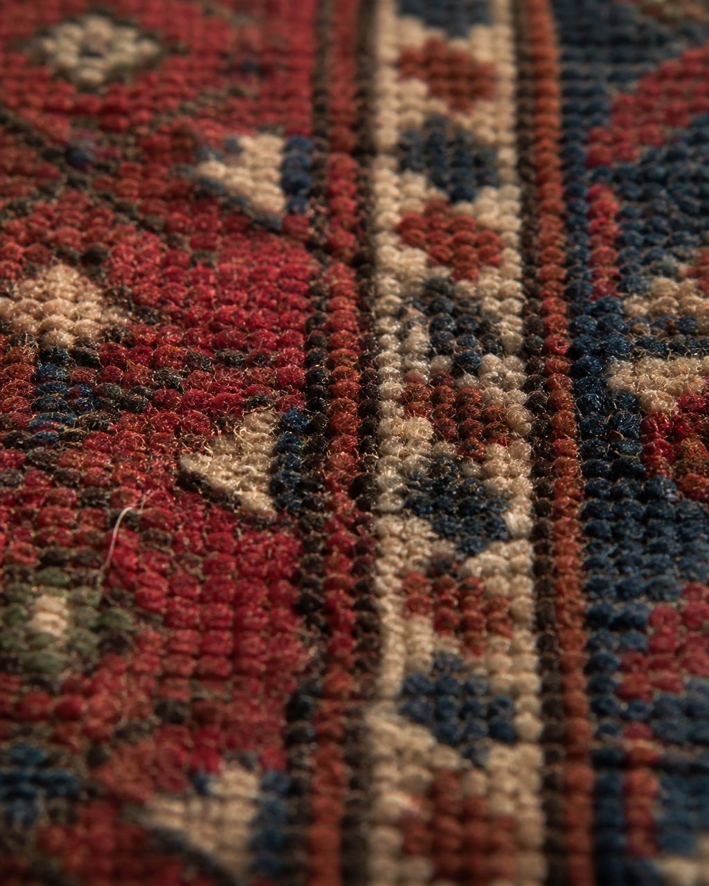Macro view of hand-tied knots in a wool rug